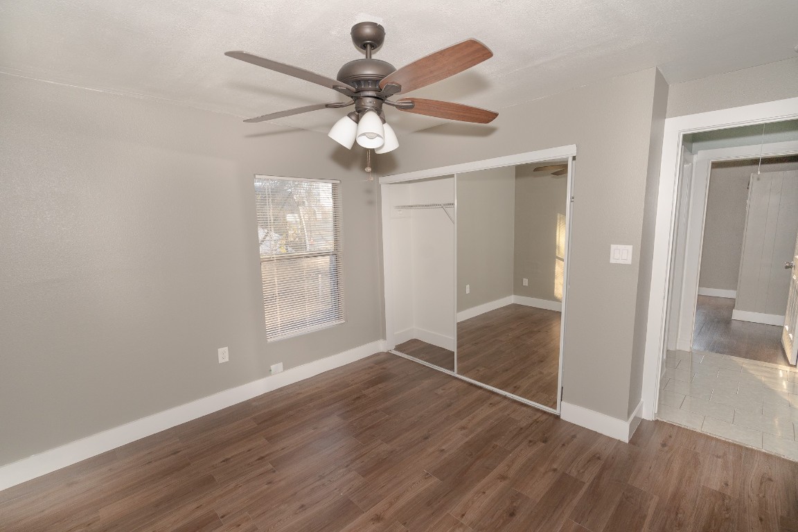 4826 Bristol Street Houston, TX 77009 - Photo 18 of 25 an empty room with wooden floor fan and windows