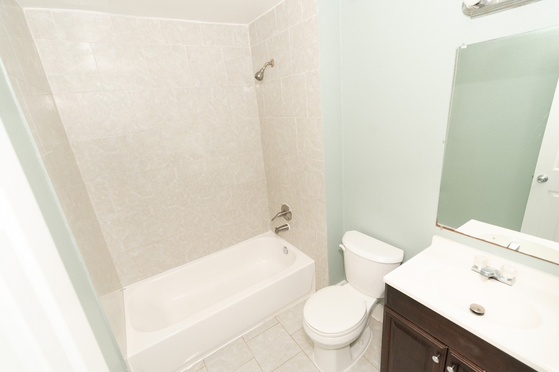 4826 Bristol Street Houston, TX 77009 - Photo 22 of 25 a white toilet sitting next to a bathroom sink