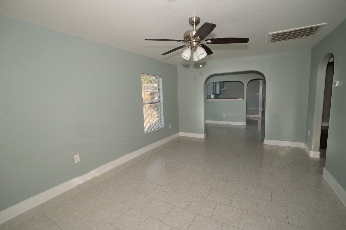 4826 Bristol Street Houston, TX 77009 - Photo 4 of 25 a view of empty room with windows and ceiling fan