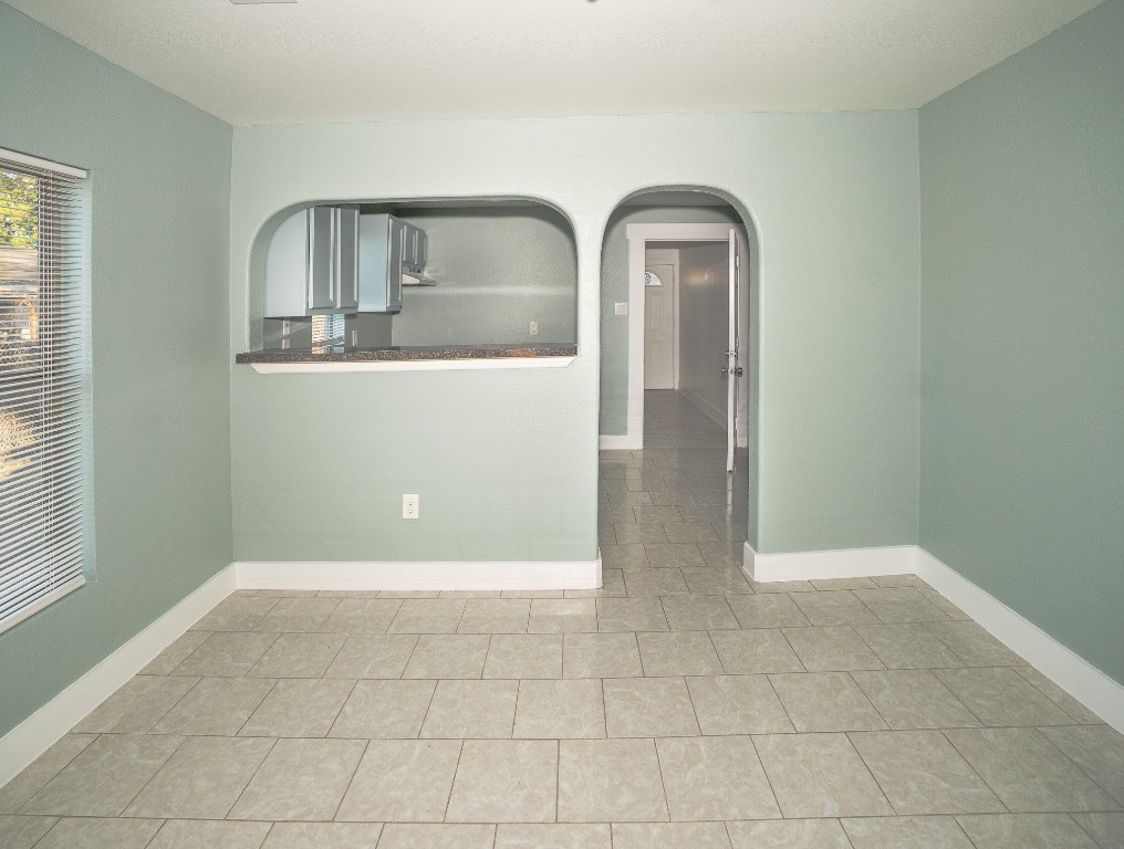 4826 Bristol Street Houston, TX 77009 - Photo 7 of 25 a view of a livingroom with wooden floor and kitchen space with a sink