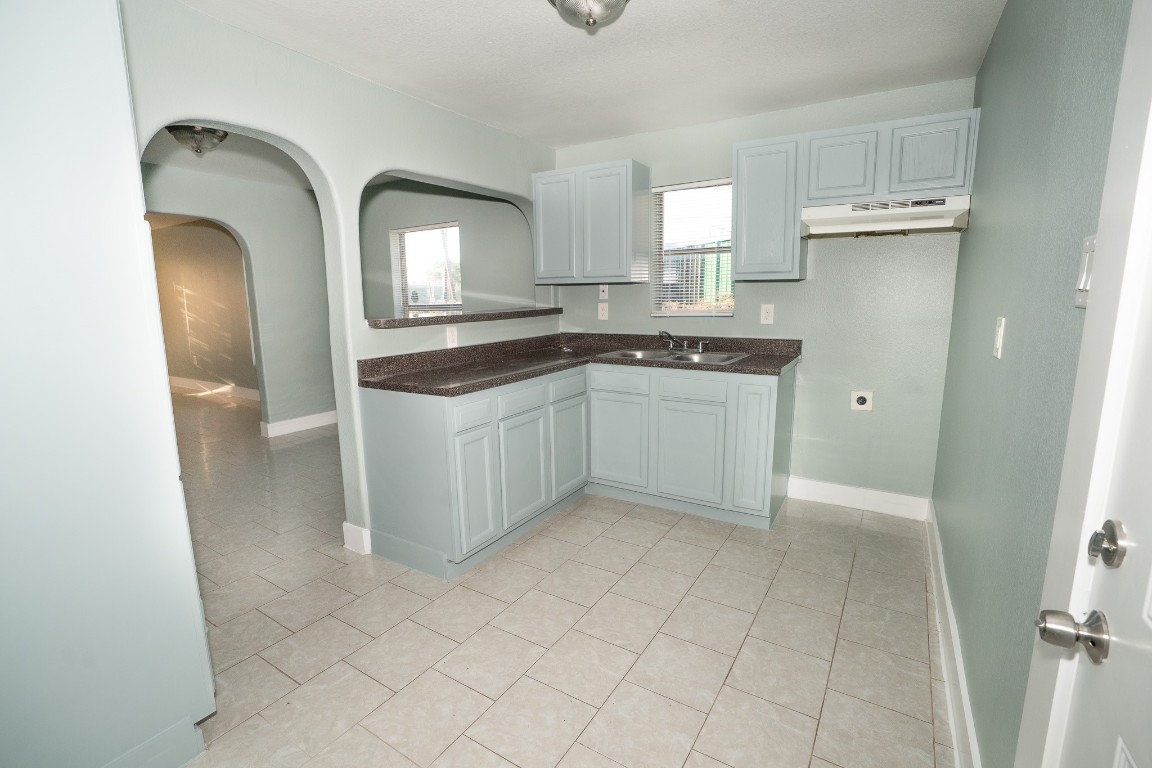 4826 Bristol Street Houston, TX 77009 - Photo 8 of 25 a kitchen with stainless steel appliances granite countertop a sink and a stove