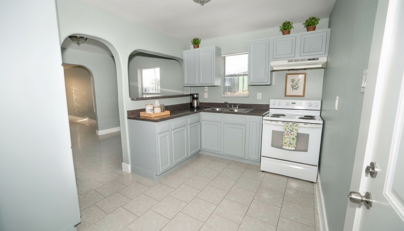 4826 Bristol Street Houston, TX 77009 - Photo 9 of 25 a kitchen with stainless steel appliances granite countertop a stove a sink and a refrigerator