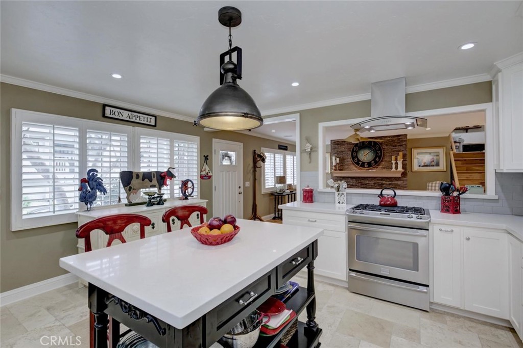 34061 Formosa Dana Point, CA 92629 - Photo 7 of 61 a kitchen that has a lot of cabinets a sink and a dining table with chairs