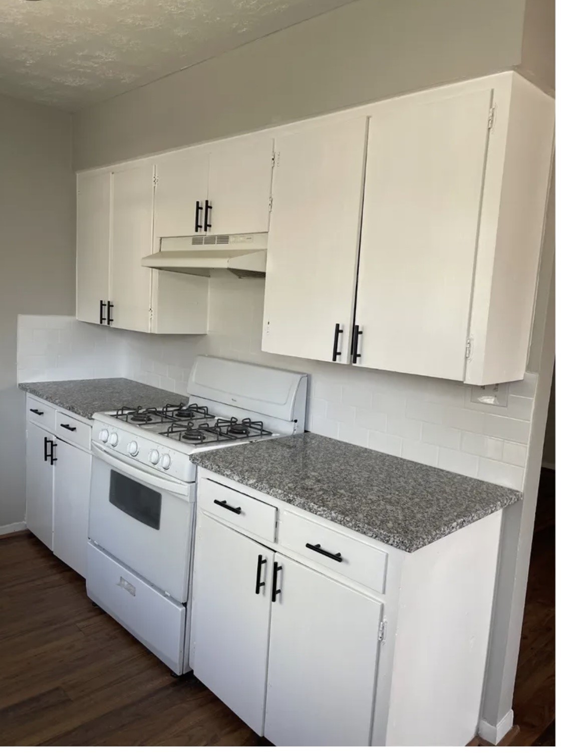 1014 East 23rd Street, Unit 3 Bryan, TX 77803 - Photo 1 of 8 a white kitchen with sink and microwave