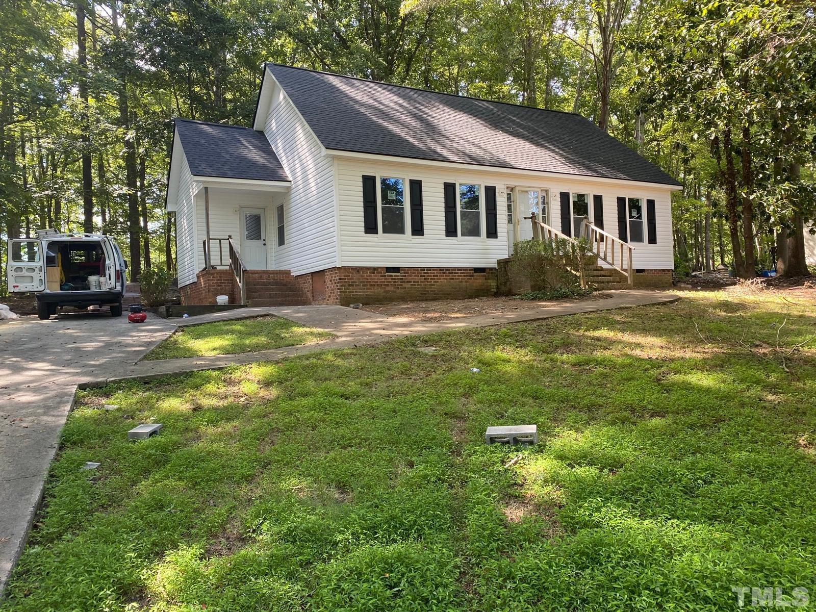 5907 Scalybark Road Durham, NC 27712 - Photo 1 of 3 a view of a house with a swimming pool and a yard