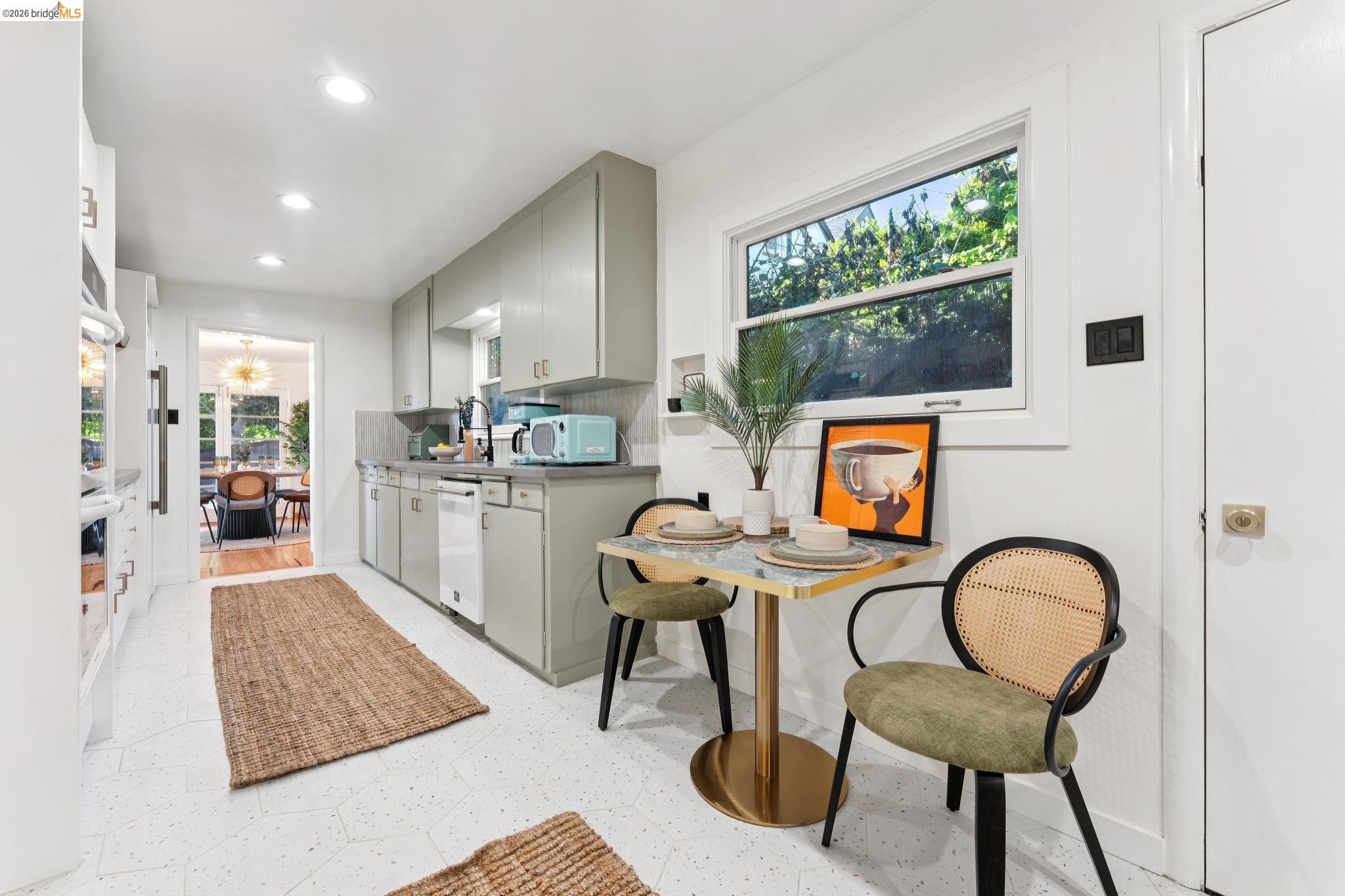 2301 Oak Street Berkeley, CA 94708 - Photo 9 of 61 Bright kitchen featuring light green cabinetry, white appliances, a window with exterior views, recessed lighting, and white flooring