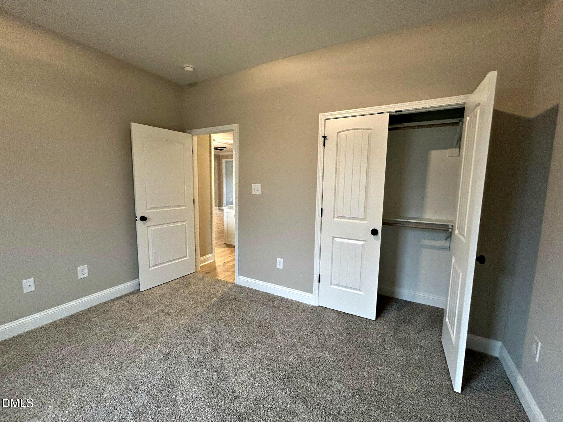 113 Prency Lane Middlesex, NC 27557 - Photo 17 of 18 an empty room with closet and wooden door
