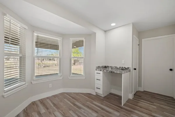 a view of wooden floor and windows in a room