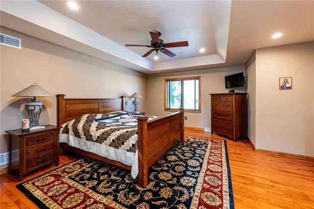 a bedroom with bed and wooden floor