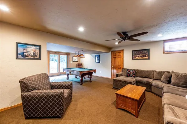 a living room with furniture a rug and a window