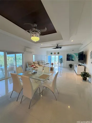 a view of a dining room with furniture and a flat screen tv
