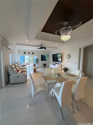 a living room with fireplace furniture and a chandelier