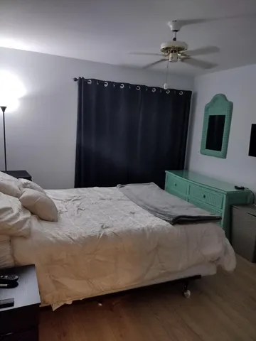 a bedroom with a bed and a mirror