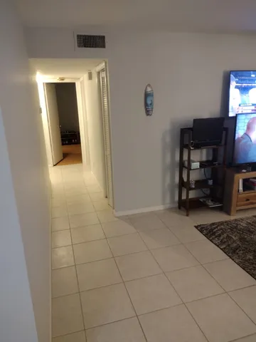 a view of an empty room with a fireplace