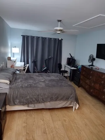 a spacious bedroom with a bed and a chandelier