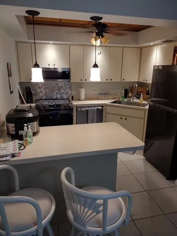 a kitchen with a sink cabinets and appliances