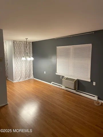 a view of a room with wooden floor