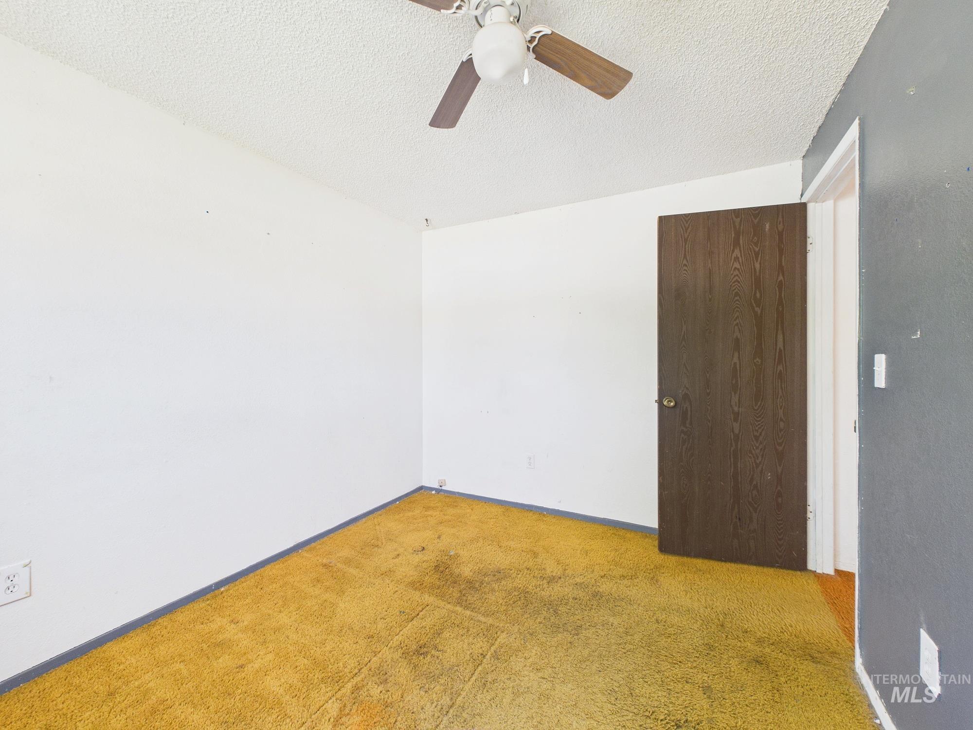 1527 North Plaza Road Emmett, ID 83617 - Photo 16 of 33 Room with textured ceiling and a ceiling fan with wood-finish blades