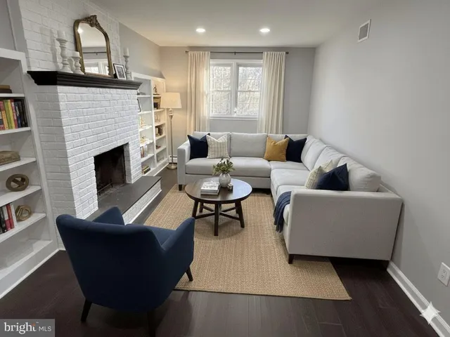 a view of a room wooden floor and fireplace