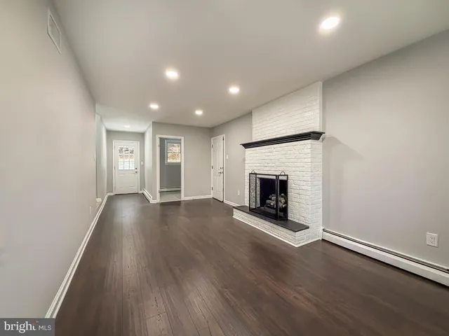 a bathroom with a granite countertop toilet sink and mirror