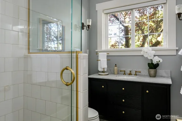 a bathroom with a window sink and mirror with window