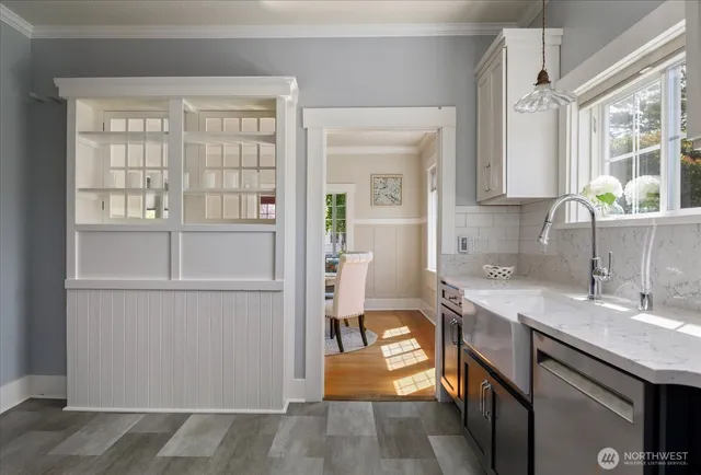 a kitchen with a sink cabinets and appliances