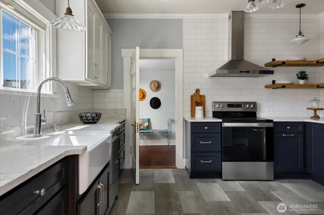 a kitchen with stainless steel appliances granite countertop a refrigerator and a stove top oven