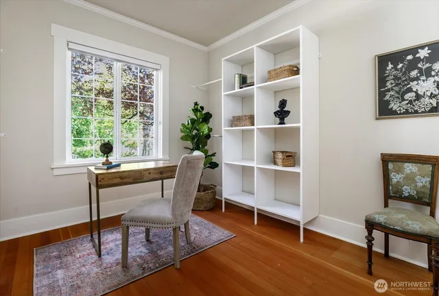 a view of a workspace with furniture and a window