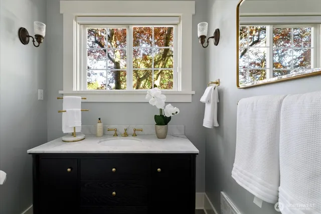 a bathroom with a sink vanity and a mirror