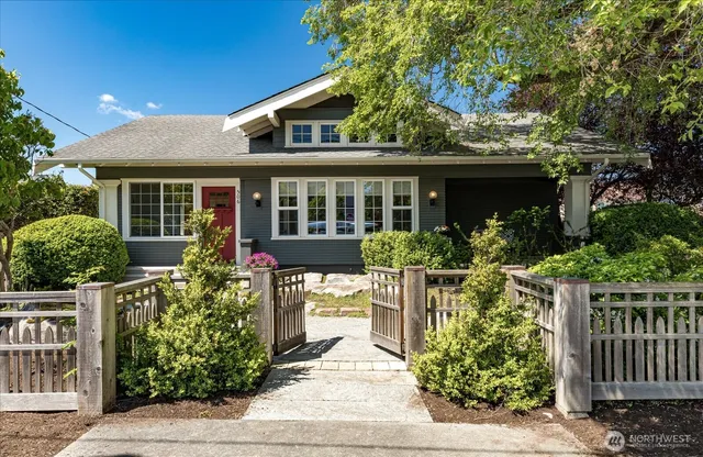 a front view of a house with a garden