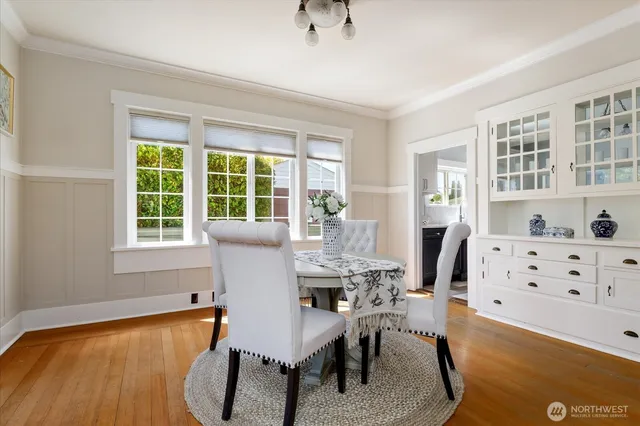 a view of a dining room with furniture window and wooden floor