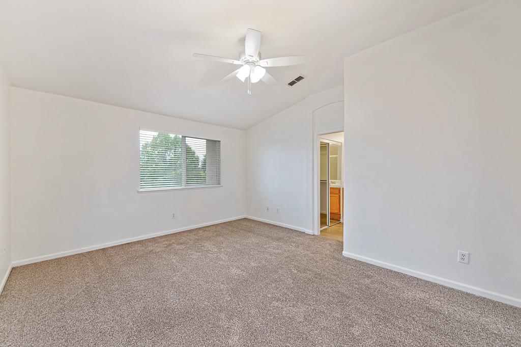 3524 Riojo Way Rancho Cordova, CA 95670 - Photo 33 of 47 an empty room with a chandelier fan and windows