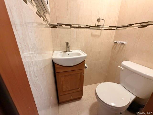 150-06 78th Road Queens, NY 11367 - Photo 11 of 22 a bathroom with a sink a toilet a mirror and vanity