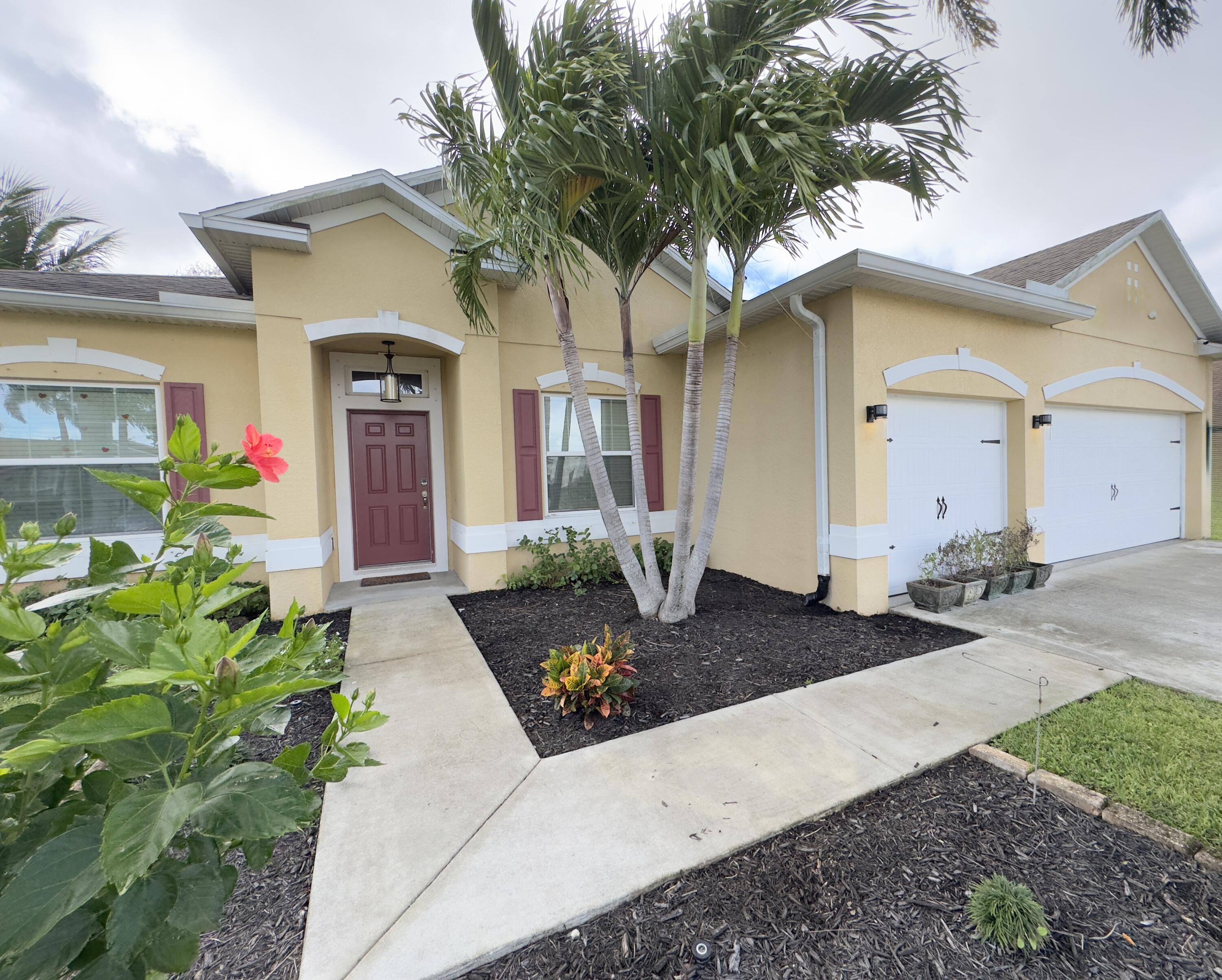 520 Southwest Dailey Avenue Port St. Lucie, FL 34953 - Photo 1 of 34 a front view of a house with garden