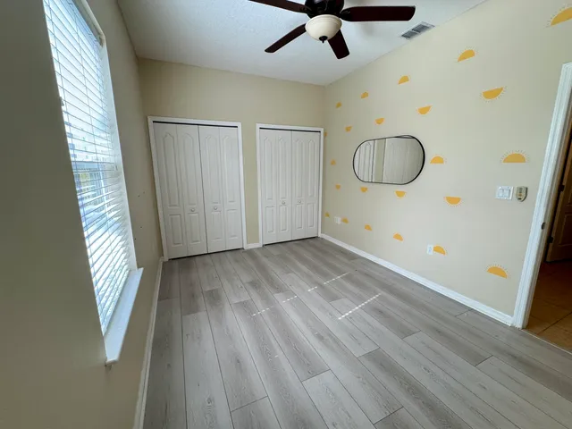 a view of empty room with wooden floor