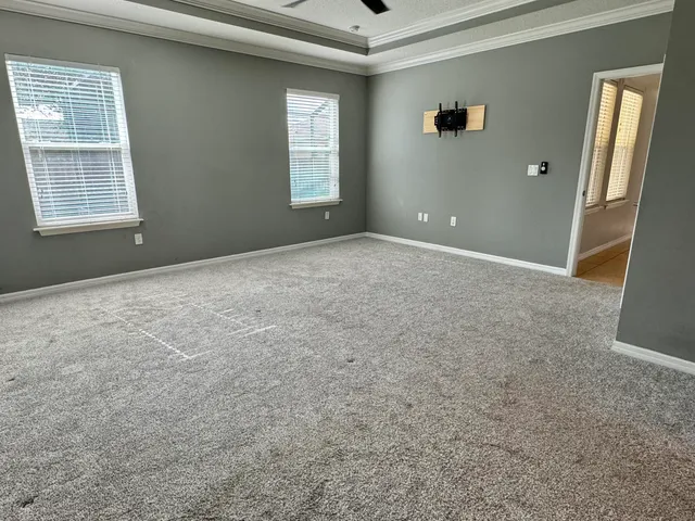 an empty room with windows and closet