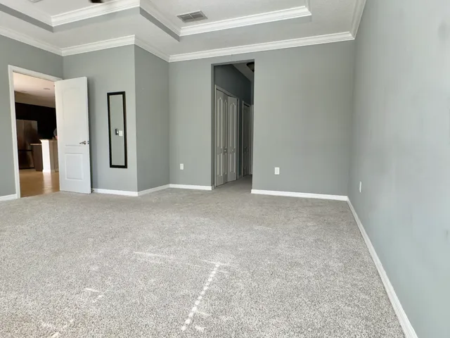 an empty room with closet and mirror