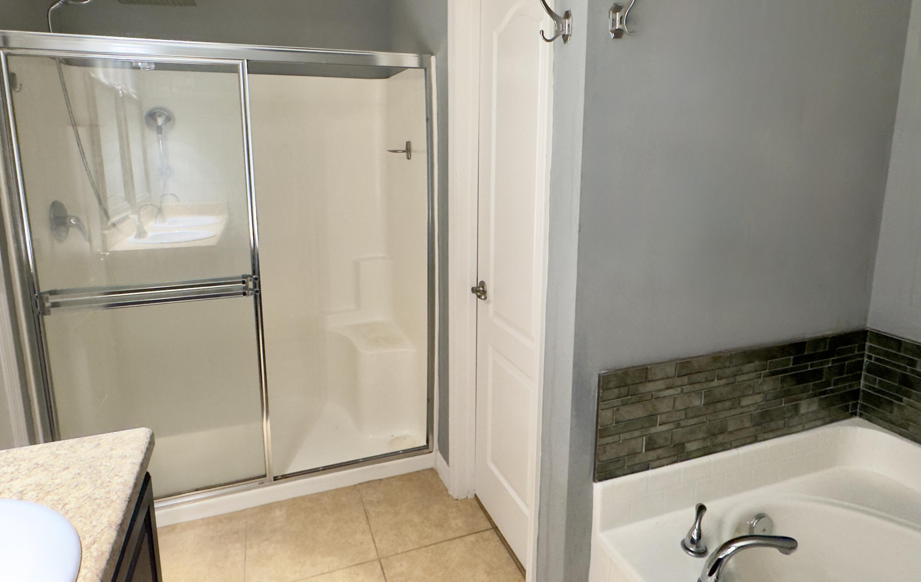 520 Southwest Dailey Avenue Port St. Lucie, FL 34953 - Photo 19 of 34 a view of a bathroom with tub and shower