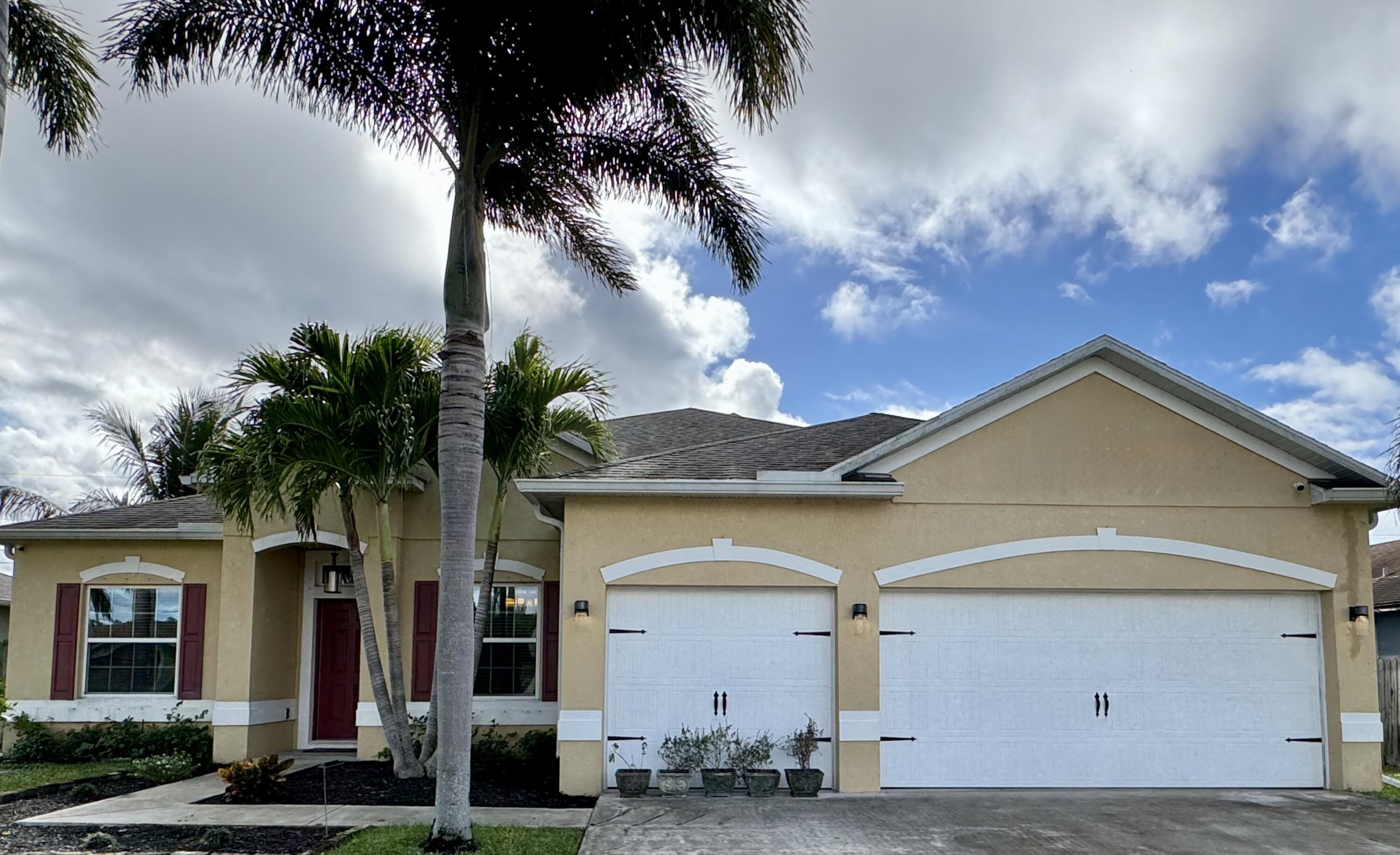 520 Southwest Dailey Avenue Port St. Lucie, FL 34953 - Photo 2 of 34 a front view of a house with a garden
