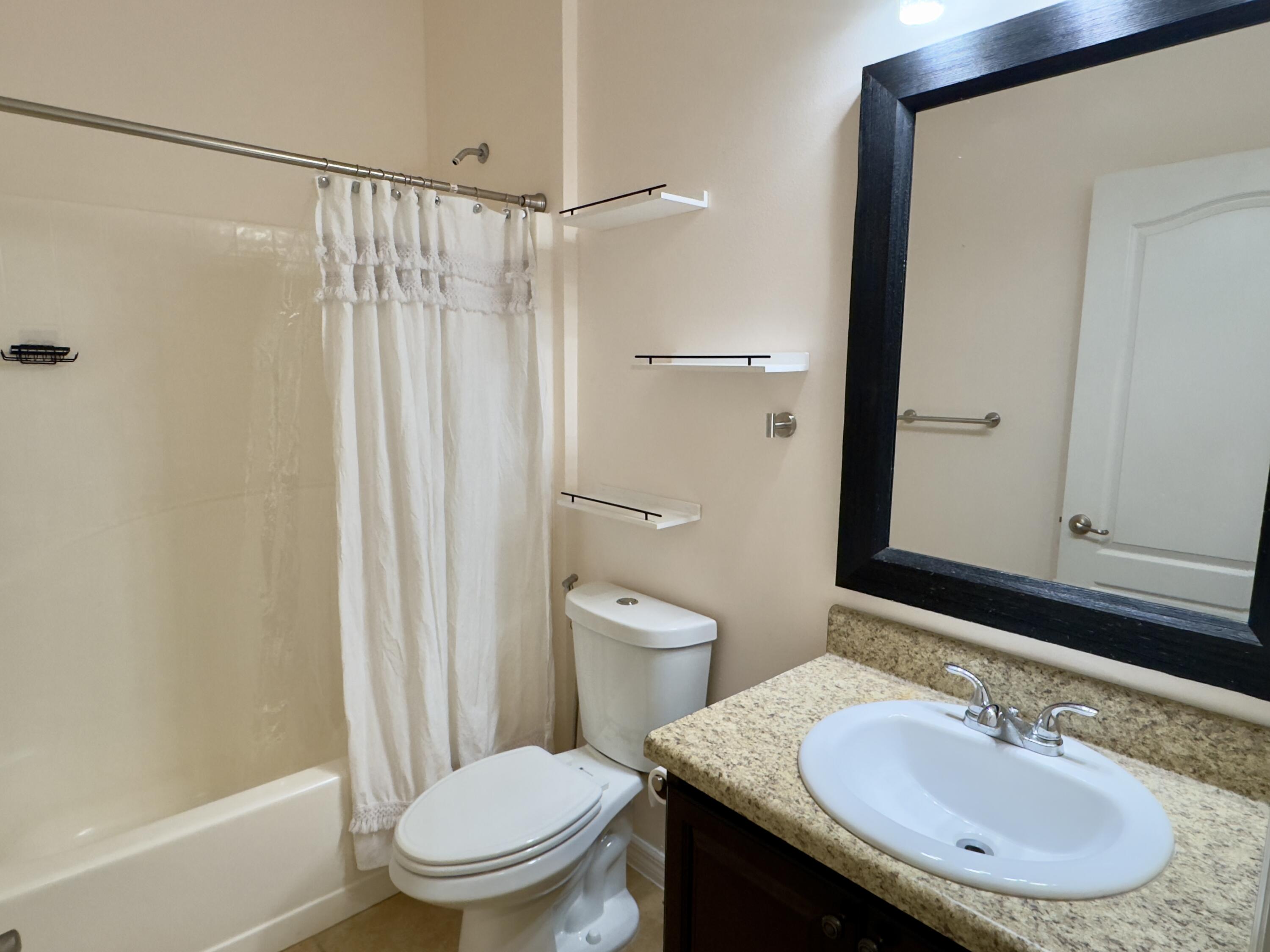 520 Southwest Dailey Avenue Port St. Lucie, FL 34953 - Photo 26 of 34 a bathroom with a sink toilet and shower