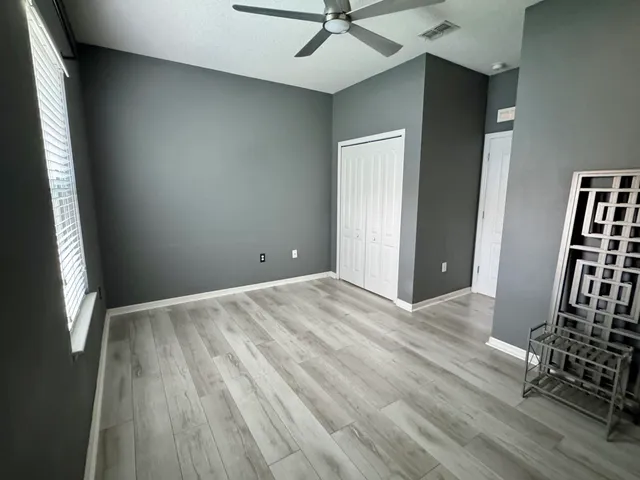 a view of a room with wooden floor