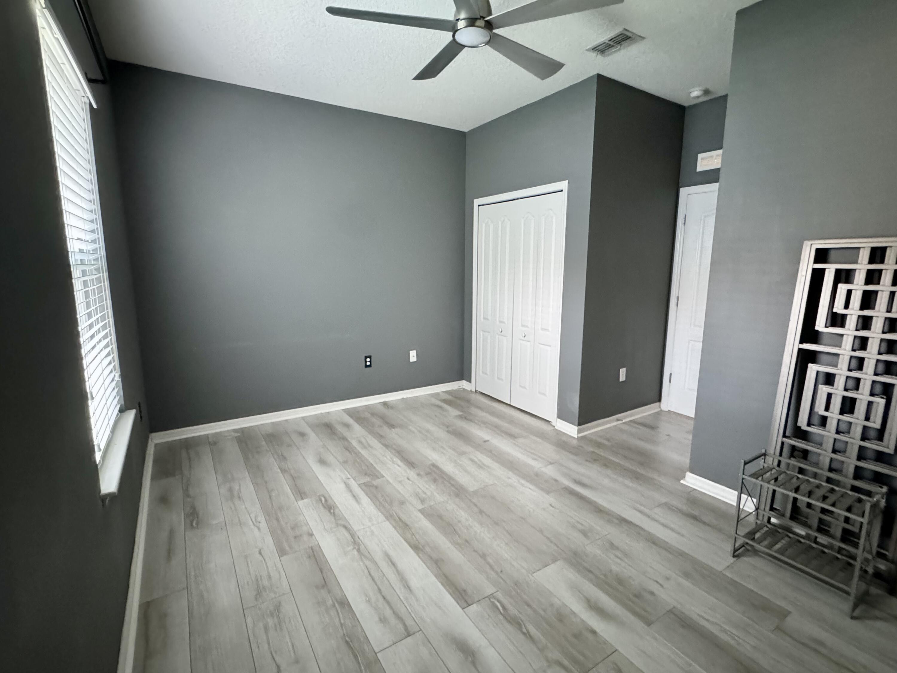 520 Southwest Dailey Avenue Port St. Lucie, FL 34953 - Photo 27 of 34 wooden floor and windows in a room