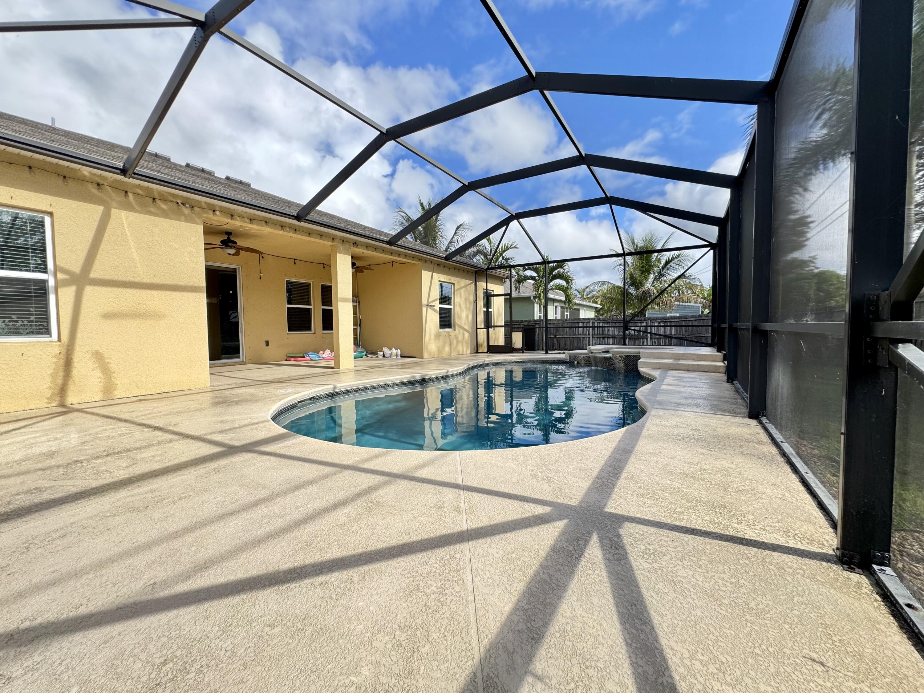 520 Southwest Dailey Avenue Port St. Lucie, FL 34953 - Photo 33 of 34 a view of a swimming pool with a porch