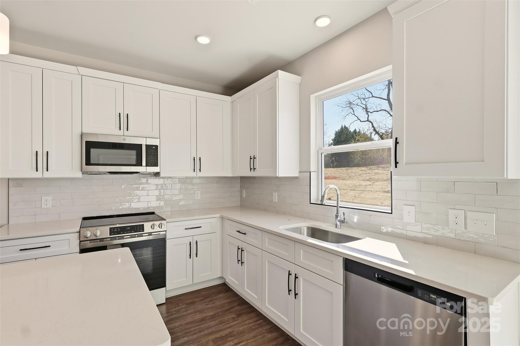 126 North Main Street Granite Falls, NC 28630 - Photo 12 of 34 a kitchen with stainless steel appliances granite countertop a sink stove and microwave