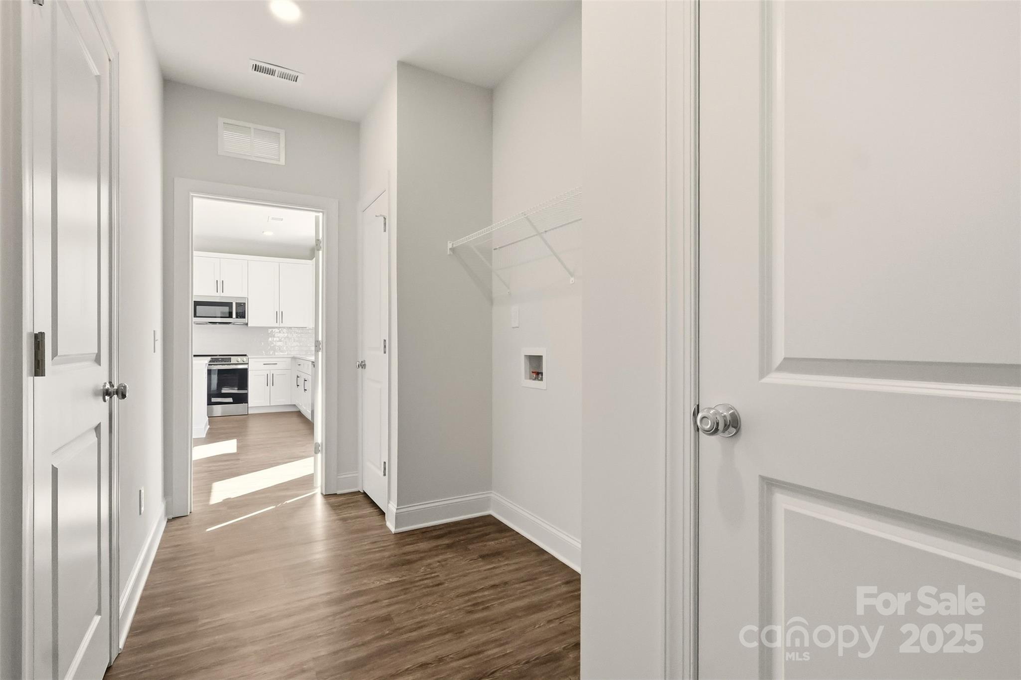 126 North Main Street Granite Falls, NC 28630 - Photo 19 of 34 a view of a hallway with wooden floor and a bathroom