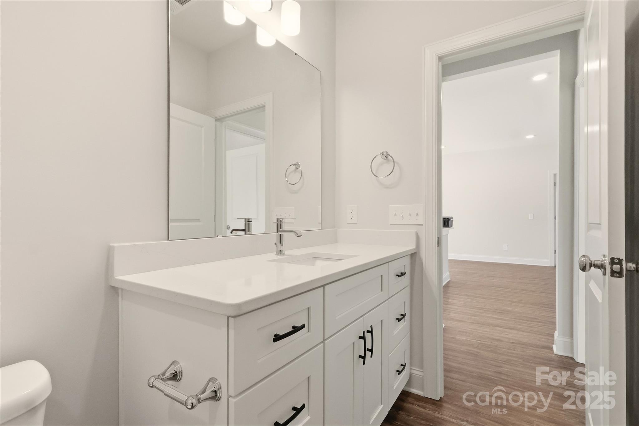 126 North Main Street Granite Falls, NC 28630 - Photo 23 of 34 a bathroom with a sink a toilet a mirror and shower