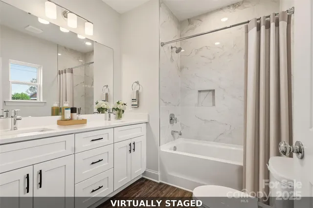 a bathroom with a shower sink vanity and mirror