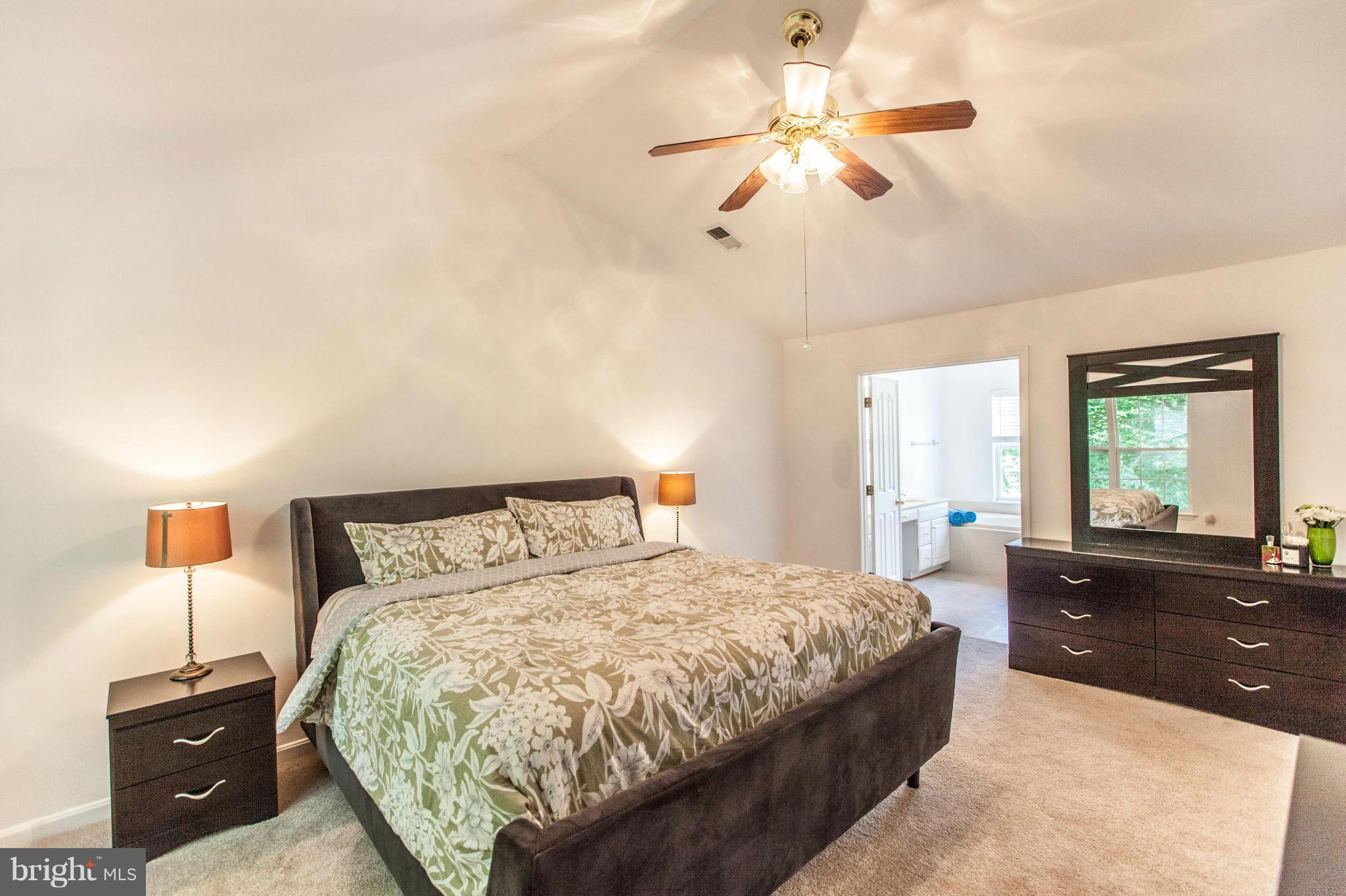 3024 Old Channel Road Laurel, MD 20724 - Photo 11 of 17 a bedroom with a large bed and a chandelier
