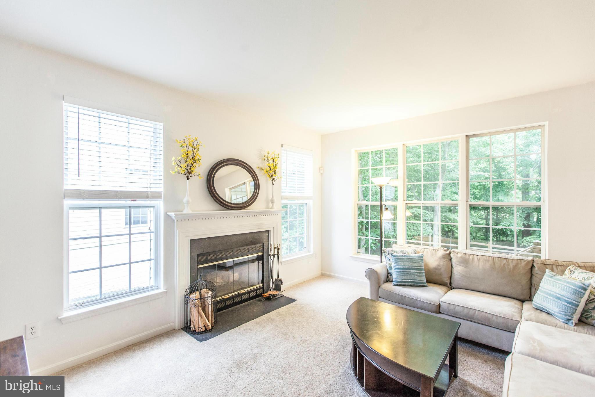 3024 Old Channel Road Laurel, MD 20724 - Photo 5 of 17 a living room with furniture a fireplace and a window