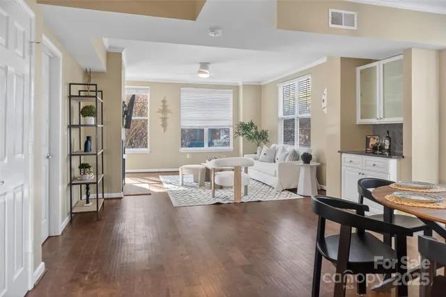 a living room with fireplace furniture and a wooden floor